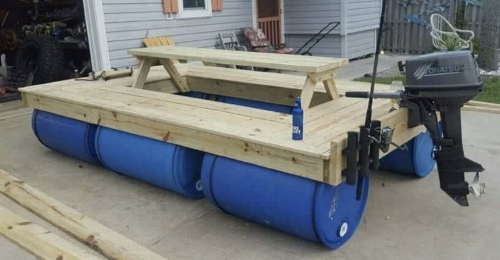 A Boat Made Of Wood And 55 Gallon Poly Drums