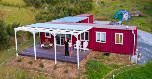 Off-The-Grid 40ft Shipping Container Home Even Charges Electric Car