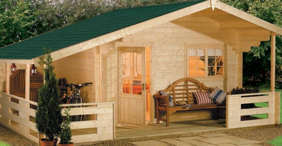 A welcoming wooden home with a sheltered porch and warm light in its windows